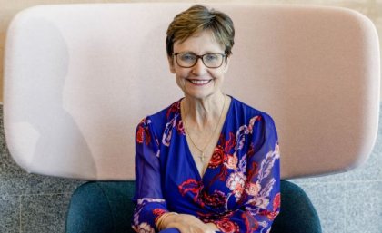 Associate Professor Rhonda Faragher seated in high back chair. Image, UQ